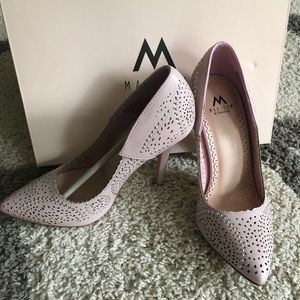 Blush colored pointed toe high heels.
